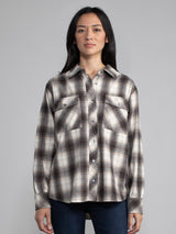 Woman wearing a plaid button down.