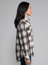 Woman wearing a plaid button down.