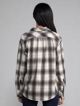 Woman wearing a plaid button down.