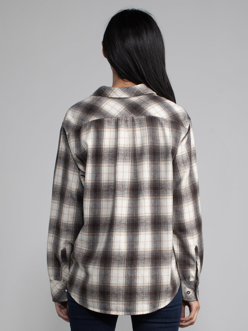 Woman wearing a plaid button down.