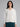 Woman wearing a white polo cardigan sweater.