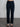 Woman wearing dark blue corduroy pants.