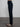 Woman wearing dark blue corduroy pants.