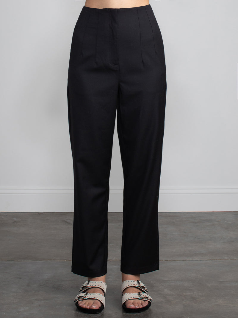 Female wearing black dress pants. 