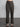 Female model wearing brown plaid dress pants