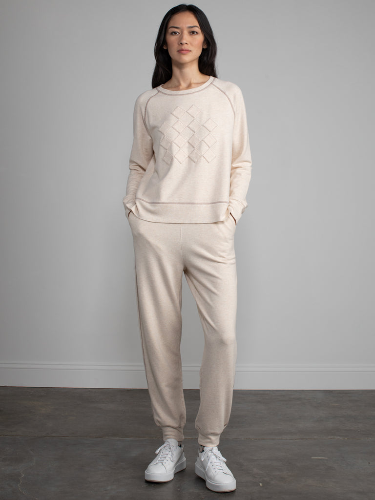 Woman wearing a matching sweatsuit.