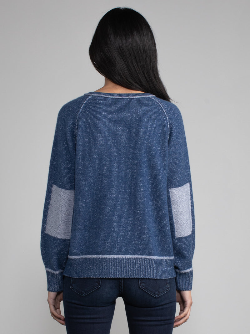 Female model in blue cashmere sweatshirt