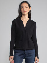 Woman wearing a fitted black cashmere jacket.