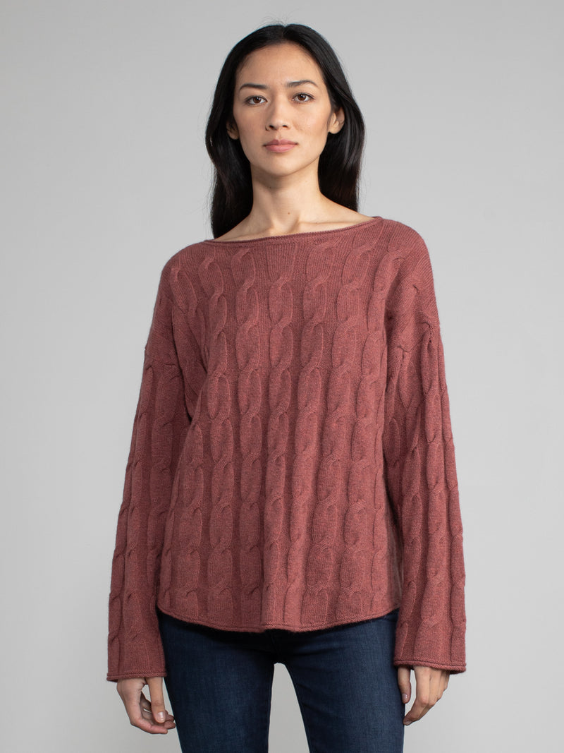 Woman wearing the Shirttail Cable Pullover in cinnamon..