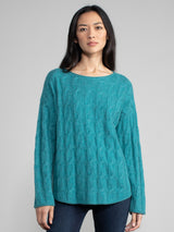 Woman wearing the Shirttail Cable Pullover in emerald.