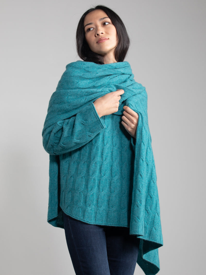 Woman wearing a EMERALD cable cashmere wrap.