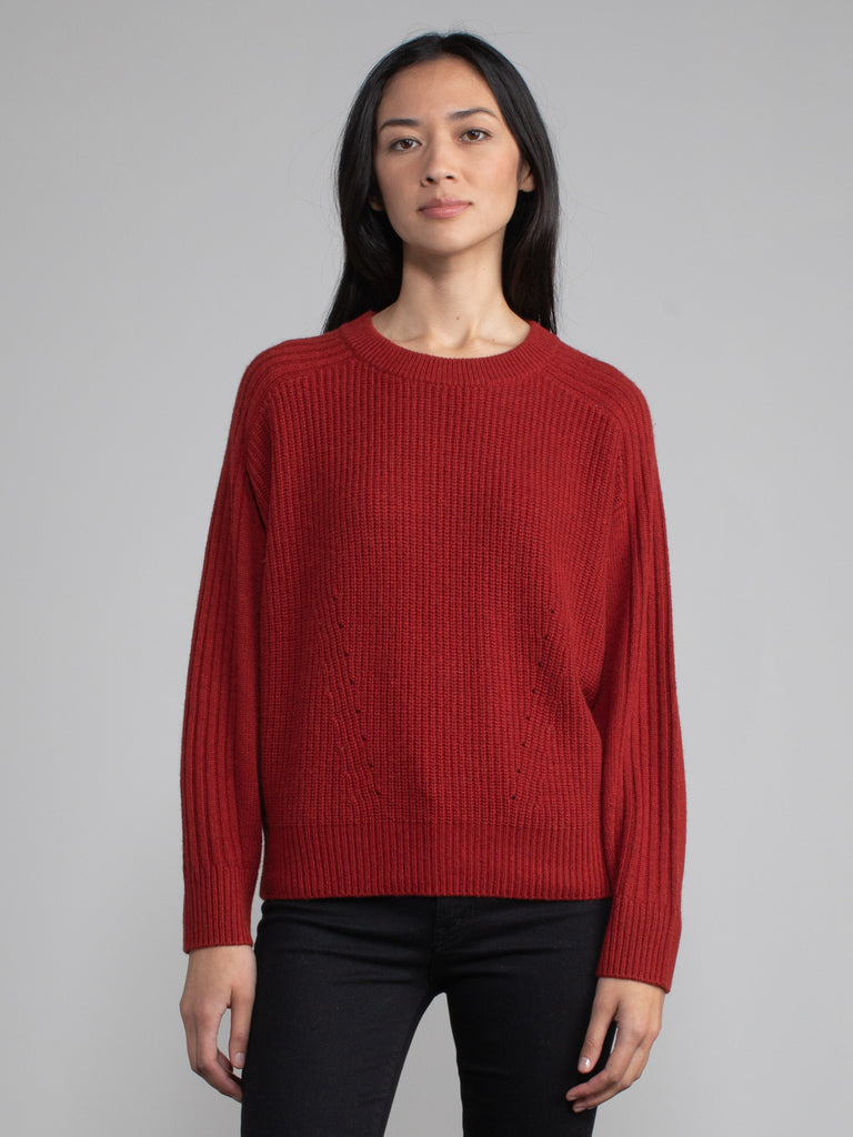 Woman wearing red sweatshirt.