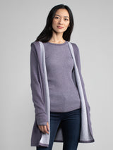 Woman in a purple and grey, long line hooded cardigan.