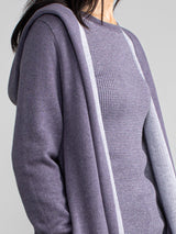 Woman in a purple and grey, long line hooded cardigan.