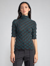 Model wearing the chocolate/teal elbow tneck and a pair of pants.