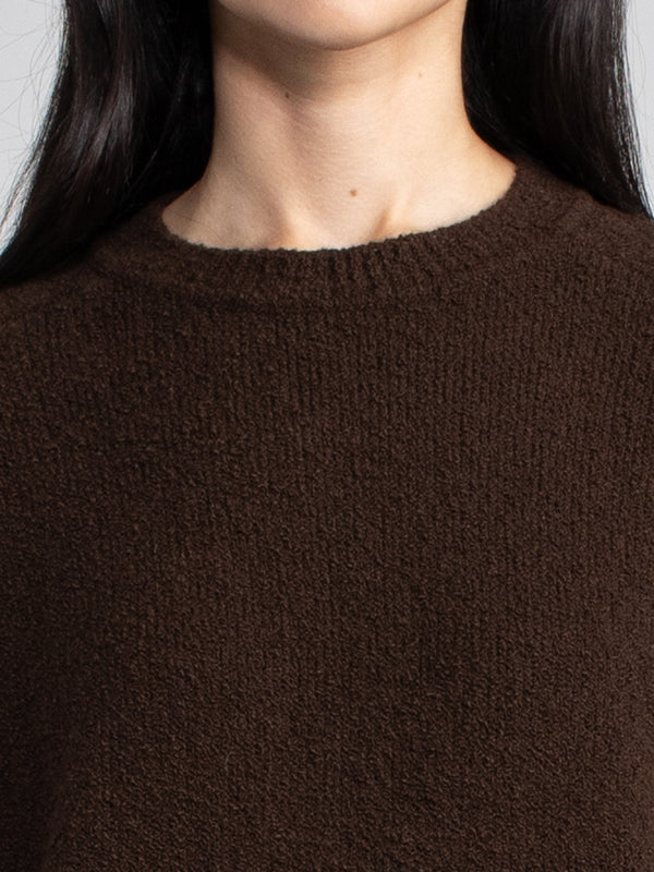 Woman wearing a brown fleece sweater.