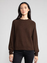 Woman wearing a brown fleece sweater.