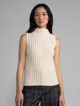 Woman wearing a white sleeveless turtleneck sweater.