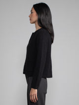 Side view of model wearing black cashmere cardigan.