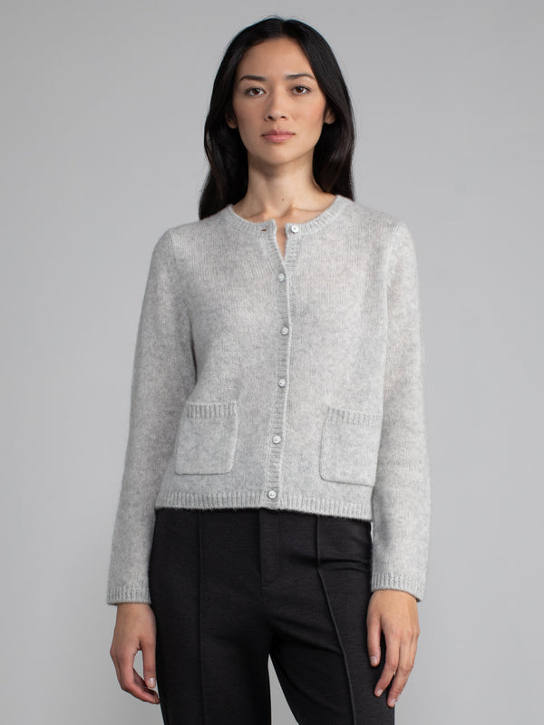 Front view of model wearing light grey cashmere cardigan.