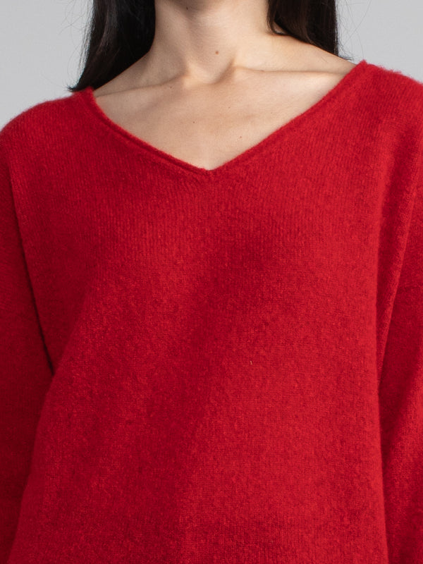 Female model wearing a red cashmere with v neck.