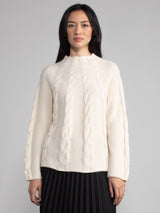 Woman wearing a white cashmere and alpaca sweater.