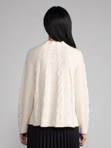Woman wearing a white cashmere and alpaca sweater.