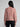 Woman wearing a red speckled knit sweater.