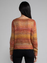 Woman wearing an orange and red knit sweater.