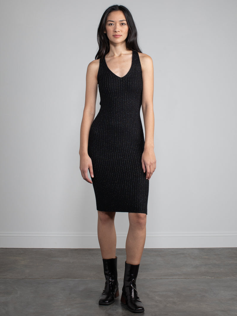 Woman wearing black sparkle dress. 
