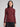 Woman wearing a fitted maroon turtleneck.
