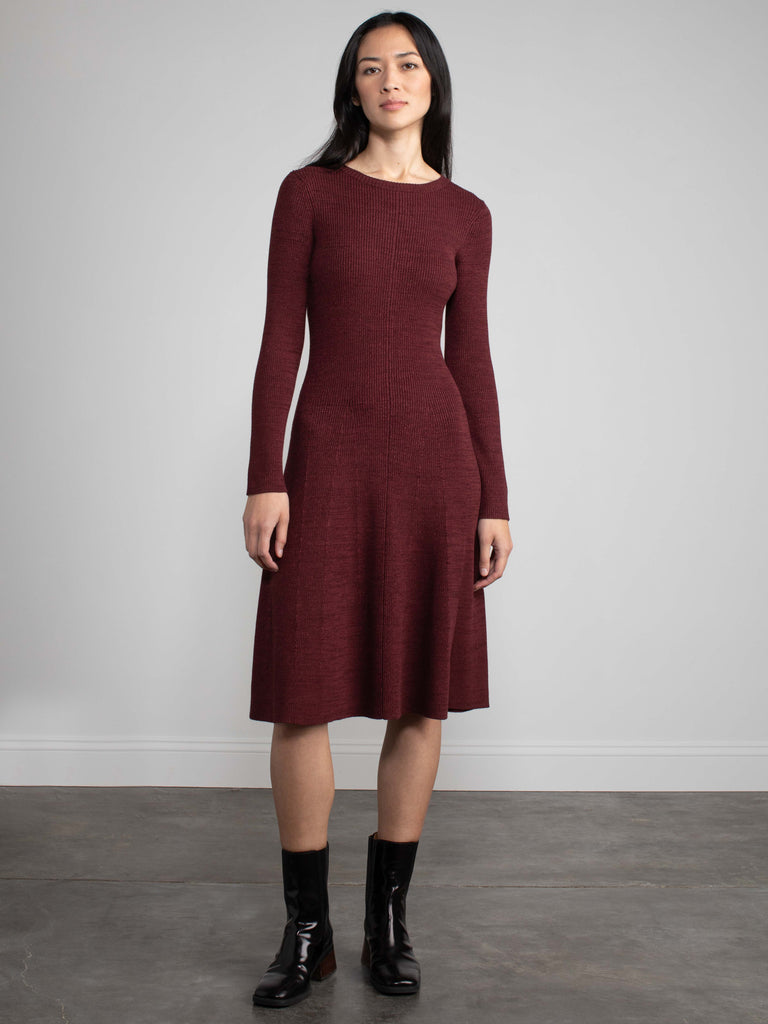 Woman wearing a red fitted knit dress.