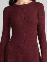 Woman wearing a red fitted knit dress.