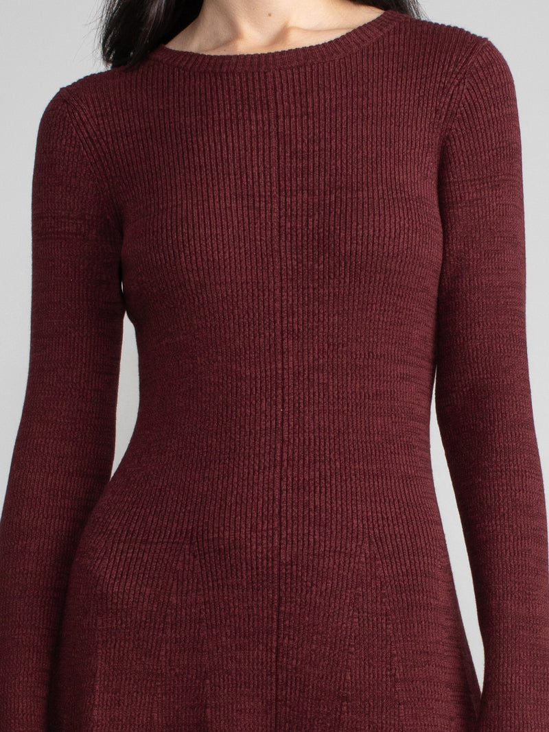 Woman wearing a red fitted knit dress.