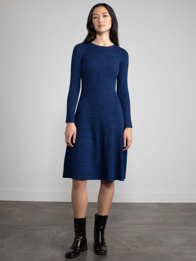 Woman wearing a blue fitted knit dress.