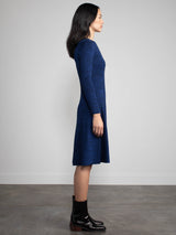 Woman wearing a blue fitted knit dress.
