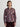 Woman wearing the Shiv Shirt, a floral patterned shirt by Margaret O'Leary, and maroon pants on a plain background.