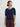 Woman wearing a navy sweater and burgundy pants on a white background