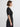 Woman wearing a black dress against a white background