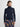Woman wearing a black turtleneck sweater with a plaid skirt on a white background