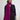 Woman wearing a Cashmere Travel Wrap by Margaret O'Leary, bright pink scarf on a plain background