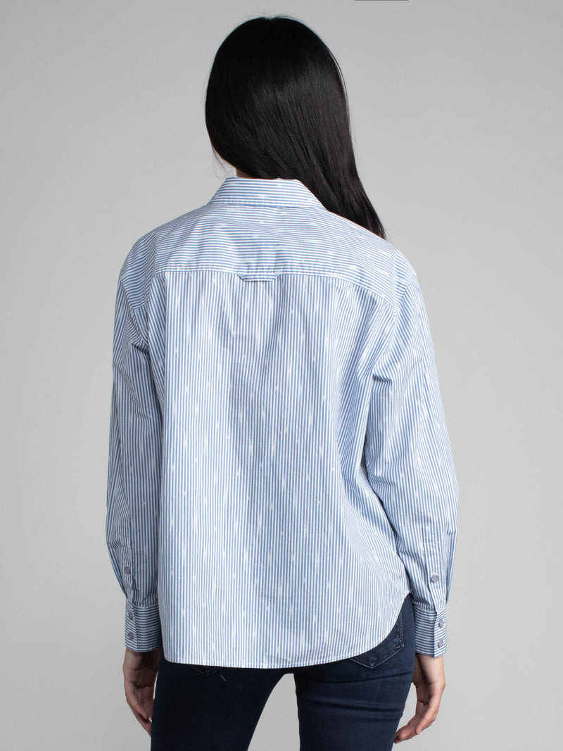 Woman wearing a cotton ikat shirt.