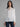 Female wearing white blouse with tie neck