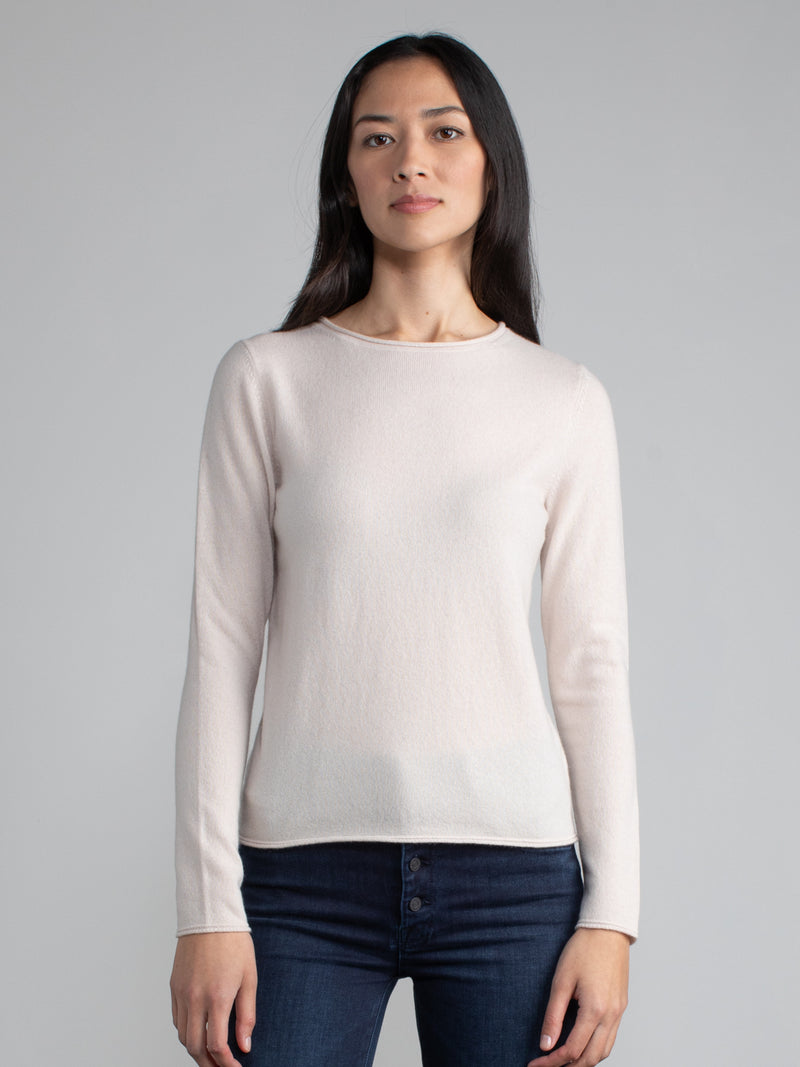 Woman wearing a pale pink cashmere tee.