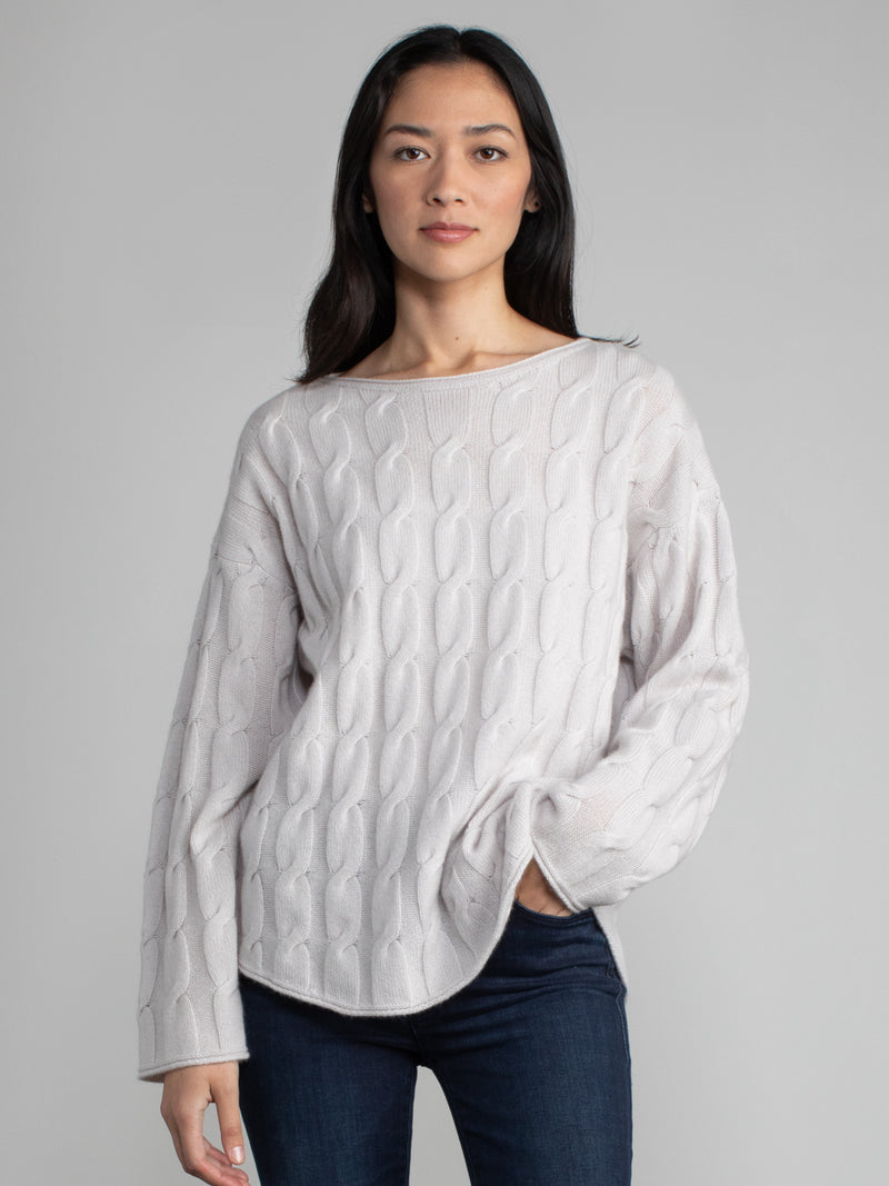 Woman wearing the Shirttail Cable Pullover in fog.