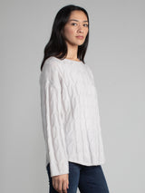 Woman wearing the Shirttail Cable Pullover in fog.