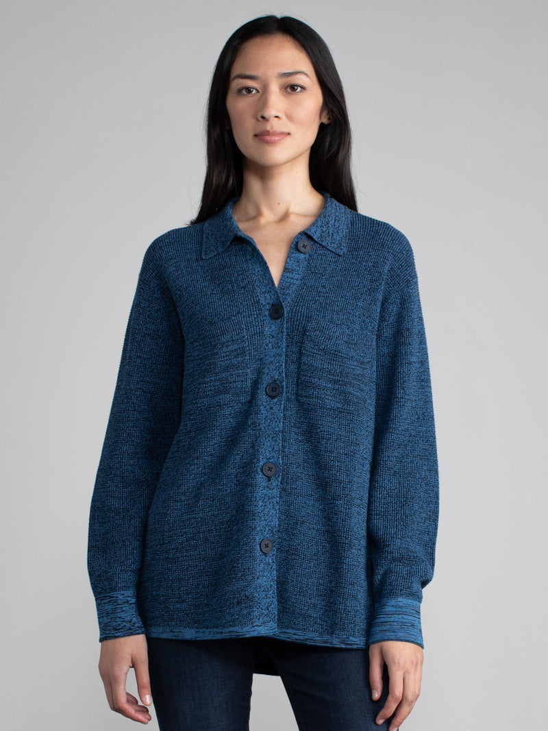 Woman in a dark blue waffle shacket.