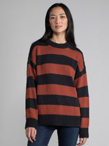 Women wearing an oversized striped sweater.