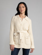 Woman wearing a white fleece button down jacket..
