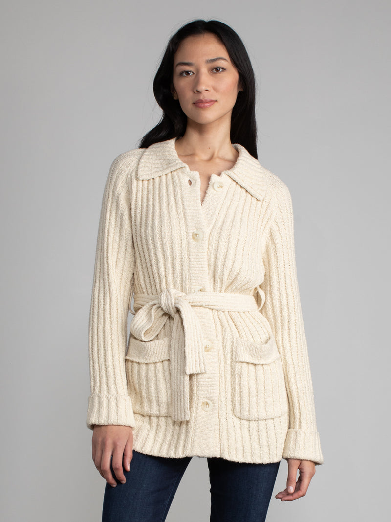 Woman wearing a white fleece button down jacket..